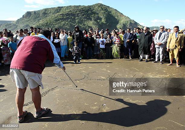 Sonny Fai's name is carved into the sand during a memorial service for missing Warriors NRL player Sonny Fai at Bethells Beach on March 10, 2009 in...