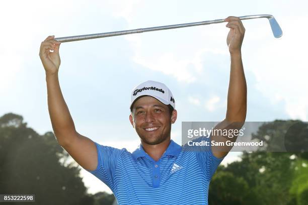 Xander Schauffele of the United States celebrates with the Calamity Jane trophy on the 18th green after winning during the final round of the TOUR...