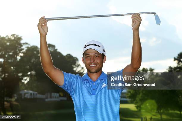Xander Schauffele of the United States celebrates with the Calamity Jane trophy on the 18th green after winning during the final round of the TOUR...