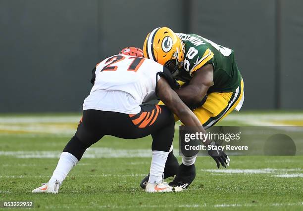 Ty Montgomery of the Green Bay Packers is tackled by Darqueze Dennard of the Cincinnati Bengals during the third quarter of their game at Lambeau...
