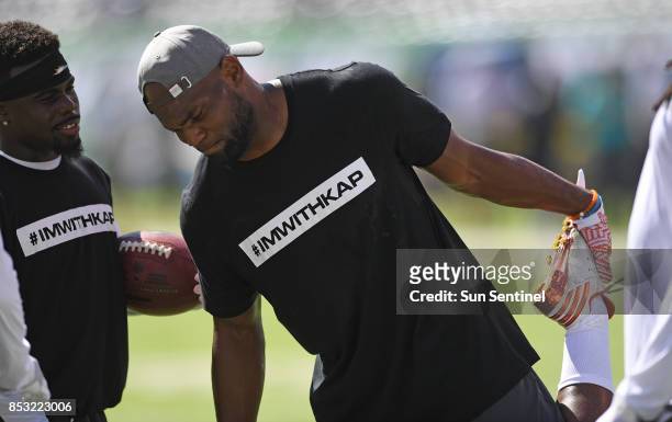 Jakeem Grant, left, and Leonte Carroo wear T-shirts supporting Colin Kaepernick during warm-ups against the New York Jets at MetLife Stadium in...