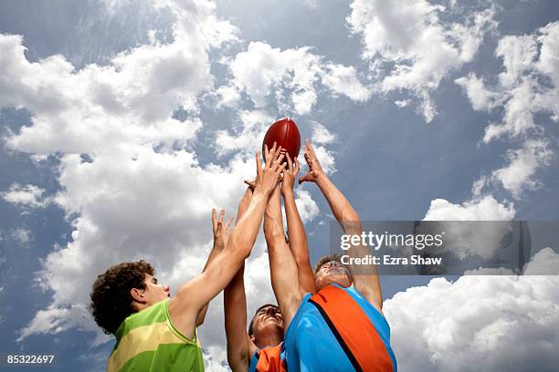 players competing for australian football - australian rules football ball stock pictures, royalty-free photos & images