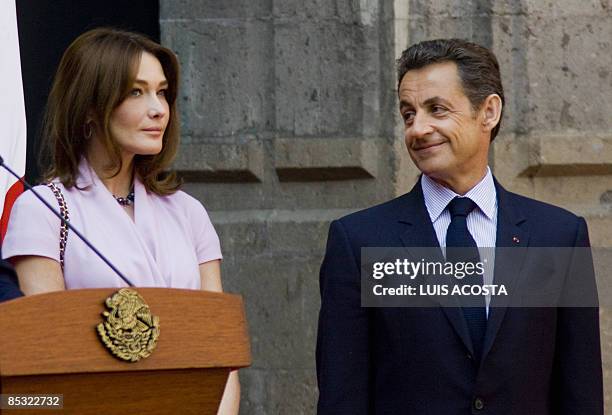 French President Nicolas Sarkozy looks at his wife Carla Bruni during a welcoming ceremony at the National Palace in Mexico City on March 9, 2009....