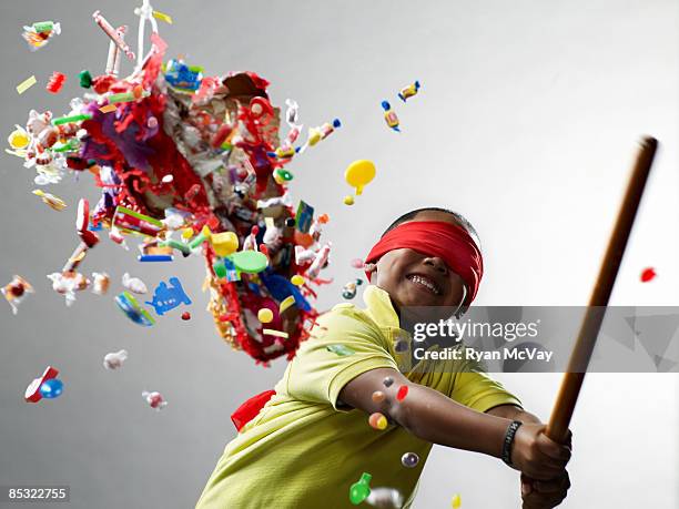 boy smiling after hitting pinata - slugs stockfoto's en -beelden