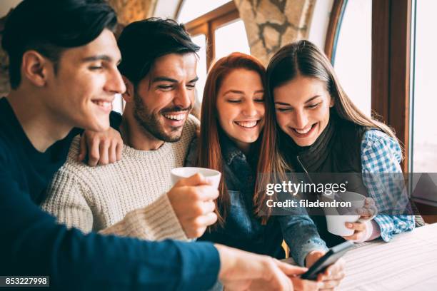 friends surfing the net at a cafe - double date stock pictures, royalty-free photos & images