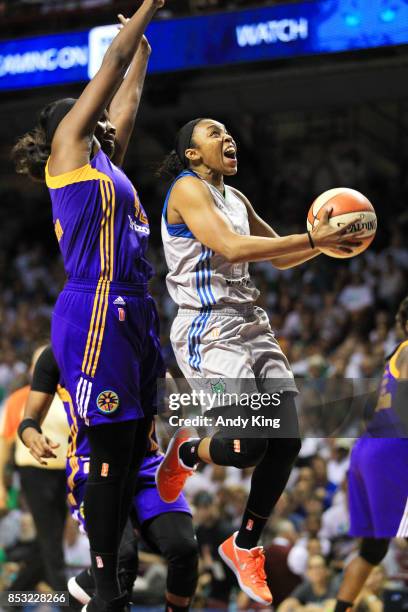 Renee Montgomery of the Minnesota Lynx shoots around Jantel Lavender of the Los Angeles Sparks during the third quarter of Game One of the WNBA...