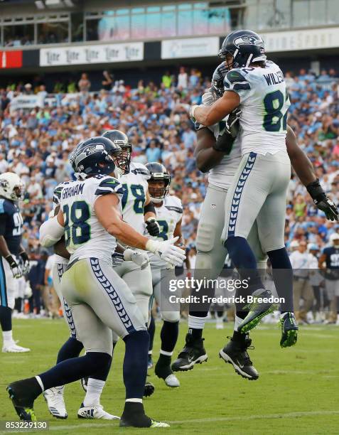 Luke Willson of the Seattle Seahawks celebrates with teammates after scoring a touchdown against the Tennessee Titans during the second half at...