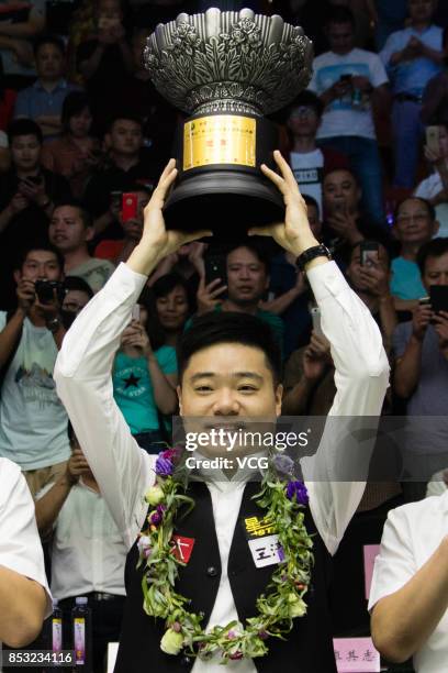 Ding Junhui of China celebrates with his trophy after winning the final match against Kyren Wilson of England on day seven of the World Open 2017 on...