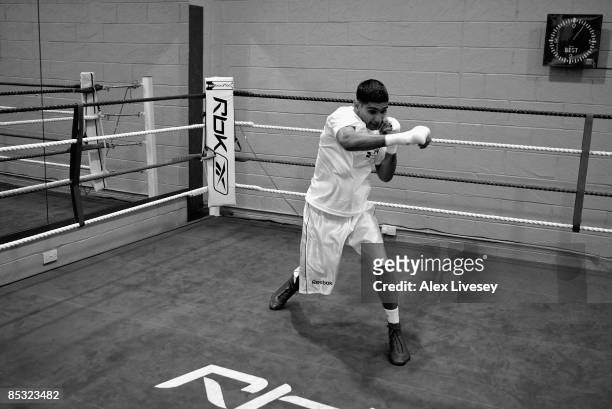 Amir Khan is seen shadow boxing during a media workout at the Gloves Community Centre on March 6, 2009 in Bolton, England. Amir Khan is due to fight...