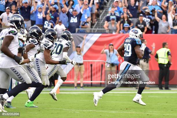 DeMarco Murray of the Tennessee Titans runs past a group of the Seattle Seahawks for a touchdown during the second half at Nissan Stadium on...