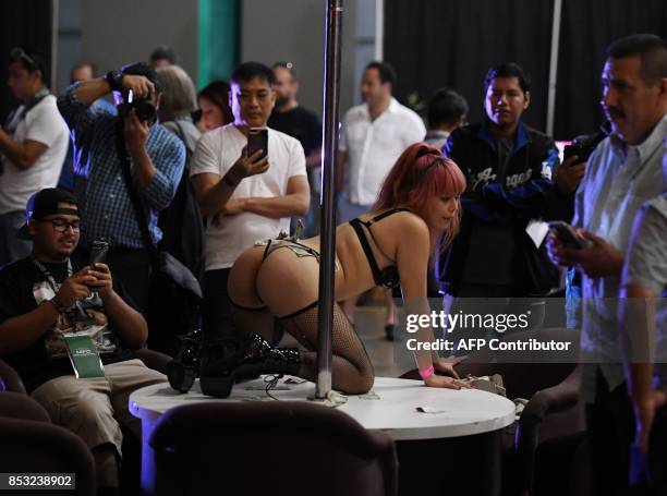 Graphic content / Fans take photos of performers during the annual 'AdultCon' - Adult Entertainment Convention in Los Angeles, California on...