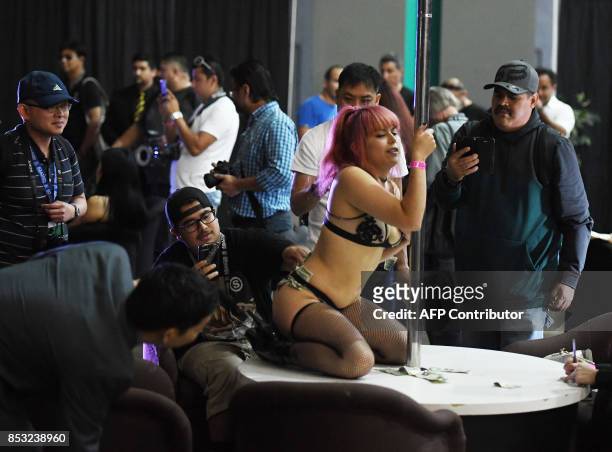 Graphic content / Fans take photos of performers during the annual 'AdultCon' - Adult Entertainment Convention in Los Angeles, California on...