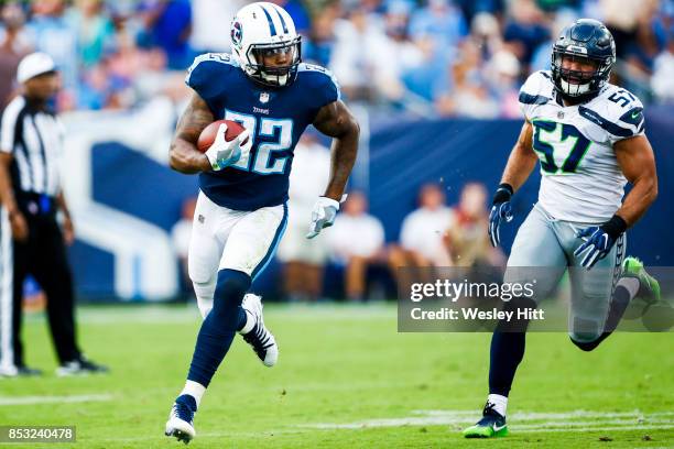 Running Back Derrick Henry of the Tennessee Titans runs the ball past Linebacker Michael Wilhoite of the Seattle Seahawks at Nissan Stadium on...