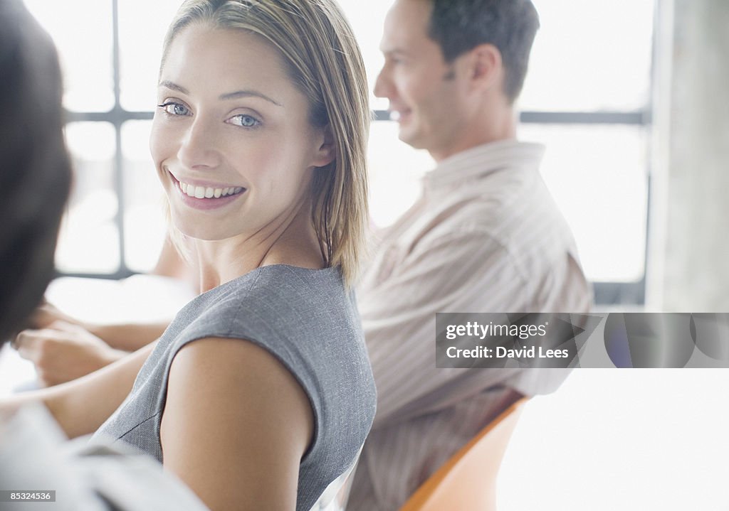 Businesswoman in meeting, smiling, portrait