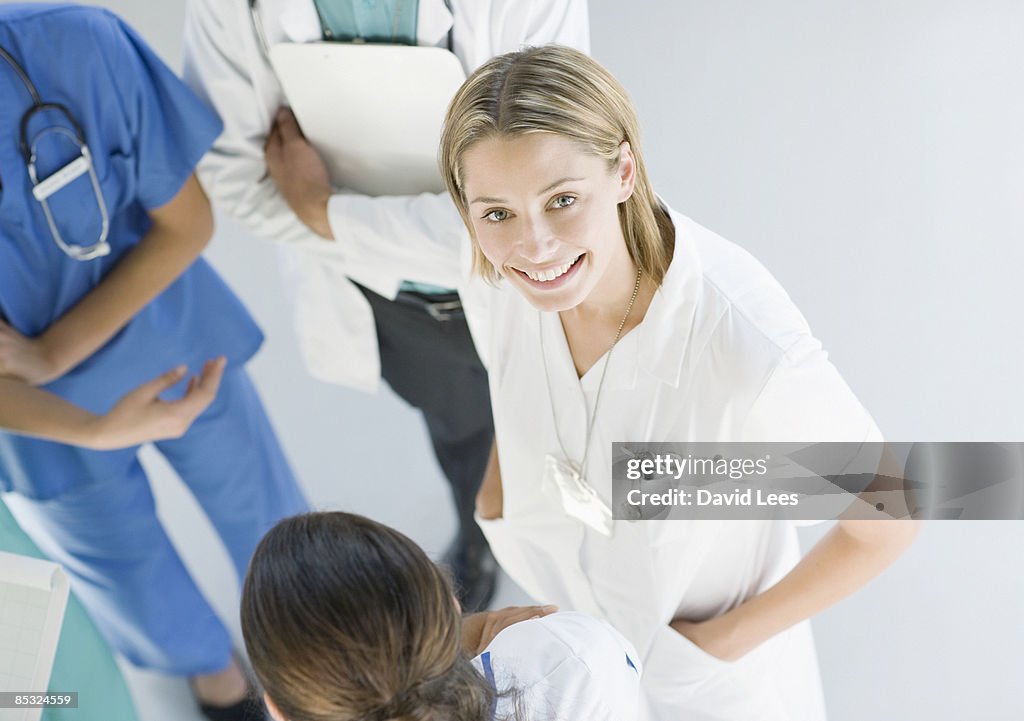 Female doctor with co-workers, overhead view