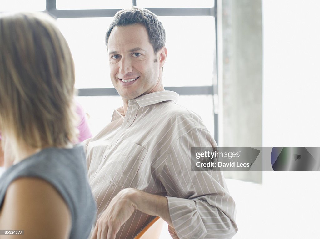 Businessman in meeting, smiling, portrait