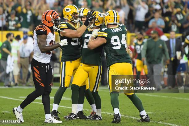 Mason Crosby of the Green Bay Packers celebrates after kicking the game winning field goal in overtime against the Cincinnati Bengals at Lambeau...