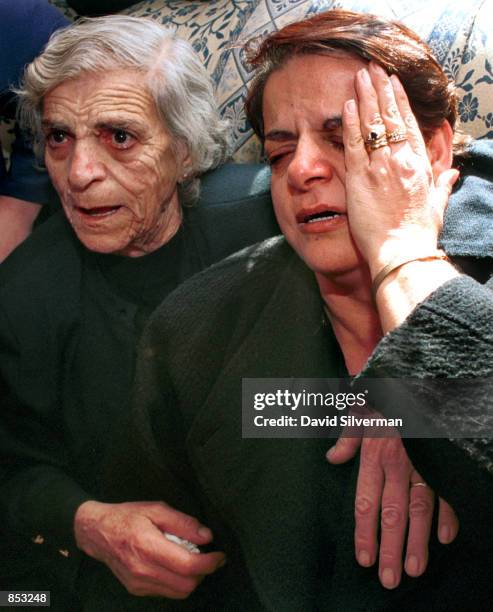 Norma Fischer, right, Palestinian Christian wife of German doctor Harald Fischer, mourns her husband along with her mother November 16, 2000 during...