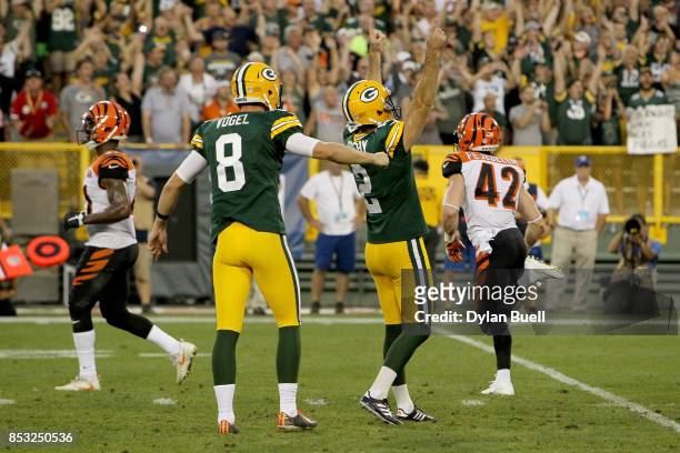 Mason Crosby and Justin Vogel of the Green Bay Packers celebrate after kicking a field goal to beat the Cincinnati Bengals 27-24 in overtime at...