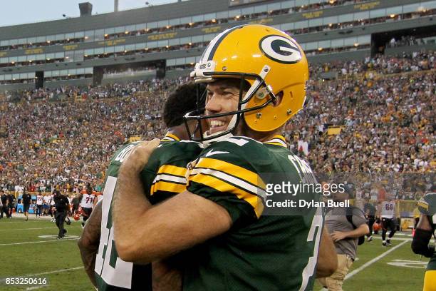 Morgan Burnett and Mason Crosby of the Green Bay Packers celebrate after beating the Cincinnati Bengals 27-24 in overtime at Lambeau Field on...