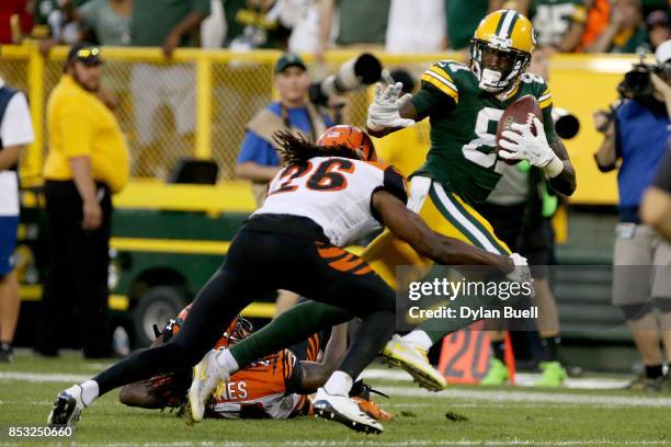 Geromino Allison of the Green Bay Packers runs with the ball while being chased by Adam Jones and Josh Shaw of the Cincinnati Bengals in overtime at...