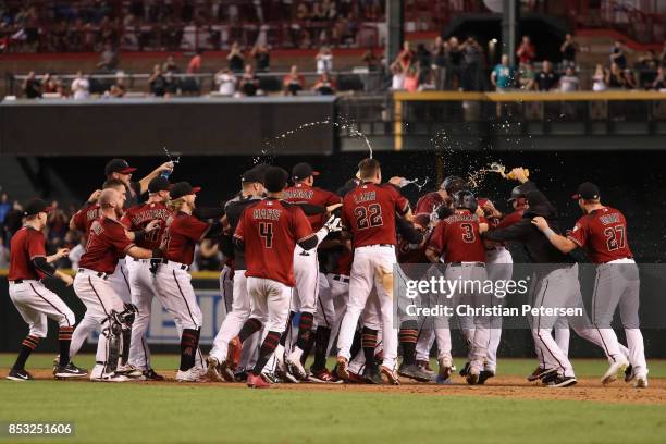 The Arizona Diamondbacks celebrate after J.D. Martinez had a game winning RBI single against the Miami Marlins during the ninth inning of the MLB...