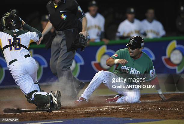 Mexico's Oscar Robles and South Africa's Alessio Angelucci in action during the 2009 World Baseball Classic on March 9, 2009 at the Estadio Foro Sol...