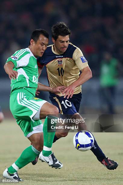 Xu Yunlong of Beijing Guoan challenges Adrianus De Groot Donny Johannes of Newcastle Jets during the AFC Champions League Group E match between...