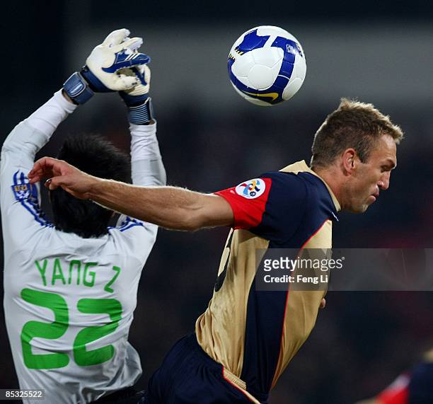Ljubo Milicevic of Newcastle Jets competes for an aerial ball with Yang Zhi of China's Beijing Guoan during the AFC Champions League Group E match...