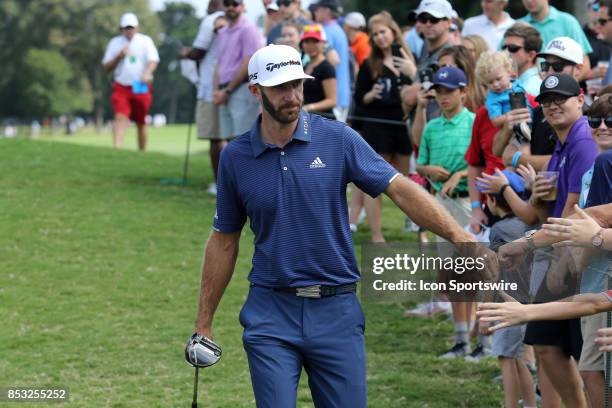 Dustin Johnson greets fans during the final round of the PGA Tour Championship on September 24, 2017 at East Lake Golf Club in Atlanta, Georgia.