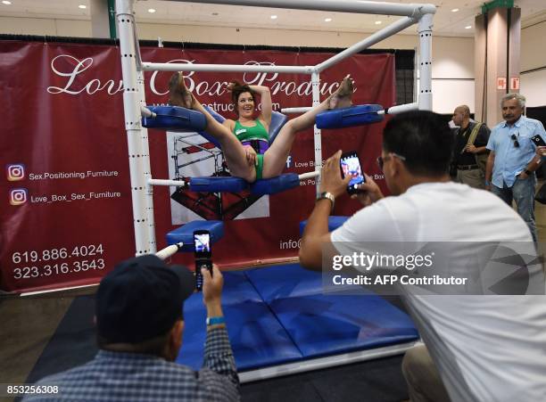Graphic content / Fans take photos of a performer during the annual 'AdultCon'- Adult Entertainment Convention in Los Angeles, California on...