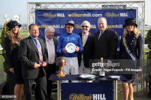 James Henderson presents jockey Adam Kirby with the trophy for winning The William Hill Lincoln on Ocean Tempest during the first day of the William...