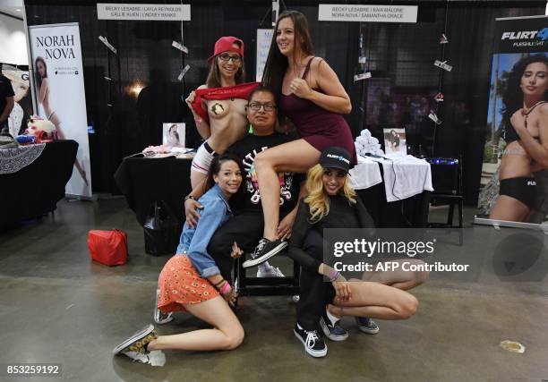 Graphic content / Fans pose for photos with performers during the annual 'AdultCon' - Adult Entertainment Convention in Los Angeles, California on...