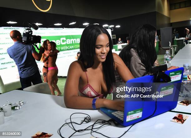 Graphic content / Webcam girls talk with viewers during the annual 'AdultCon' Adult Entertainment Convention in Los Angeles, California on September...