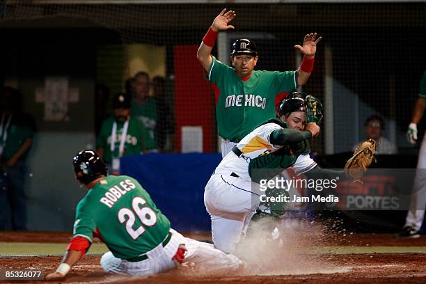 Oscar Robles of Mexico scores a run and Kyle Botha of South Africa looks for the ball during the World Baseball Classic 2009 on March 9, 2009 in...