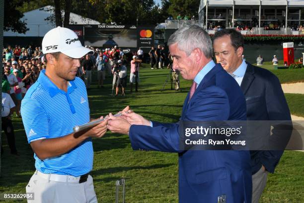 Commissioner Jay Monahan presents Xander Schauffele with the replica Calamity Jane trophy following Schauffele's win in the final round of the TOUR...