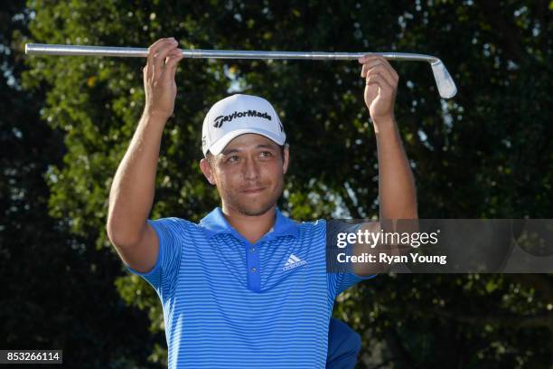 Xander Schauffele holds up the replica Calamity Jane trophy following his victory in the final round of the TOUR Championship, the final event of the...