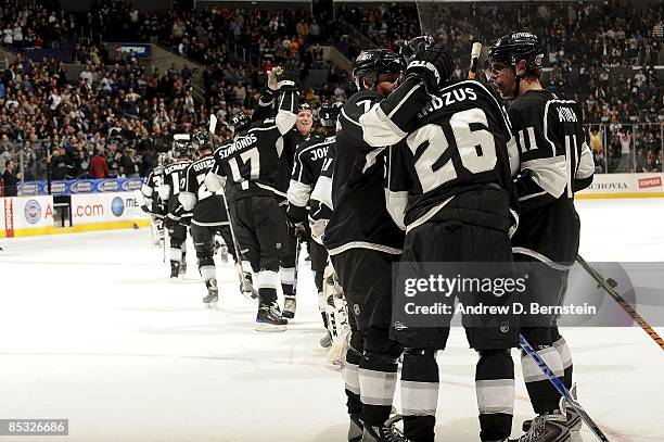 Michal Handzus of the Los Angeles Kings is congratulated by teammates after making a hat trick game winning shot against the Dallas Stars during the...