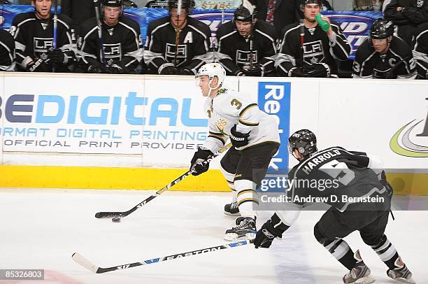 Stephane Robidas of the Dallas Stars handles the puck against Peter Harrold of the Los Angeles Kings during the game on March 5, 2009 at Staples...