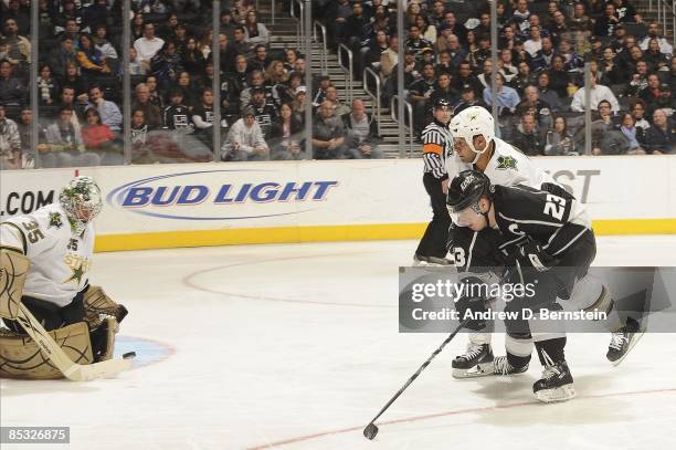 Marty Turco and Trevor Daley of the Dallas Stars defend against a shot attempted by Dustin Brown of the Los Angeles Kings during the game on March 5,...