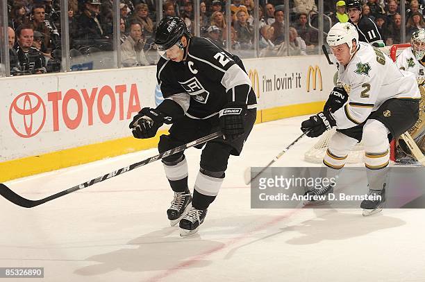 Niklas Grossman of the Dallas Stars chases the puck against Dustin Brown of the Los Angeles Kings during the game on March 5, 2009 at Staples Center...