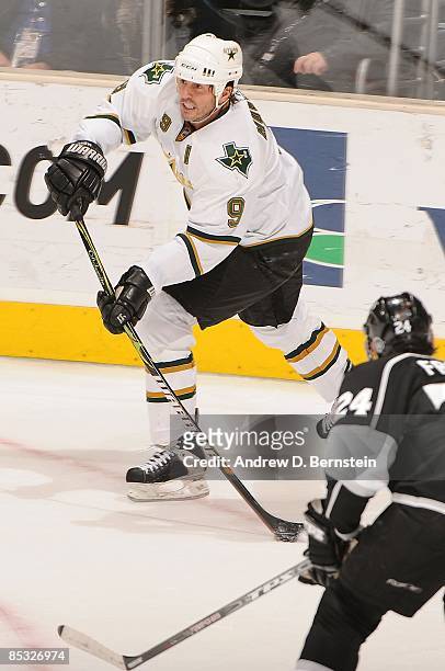 Mike Modano of the Dallas Stars passes the puck against Alexander Frolov of the Los Angeles Kings during the game on March 5, 2009 at Staples Center...