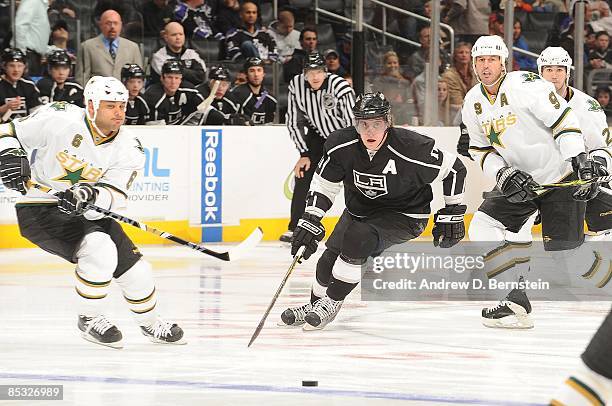 Trevor Daley of the Dallas Stars chases the puck against Anze Kopitar of the Los Angeles Kings during the game on March 5, 2009 at Staples Center in...