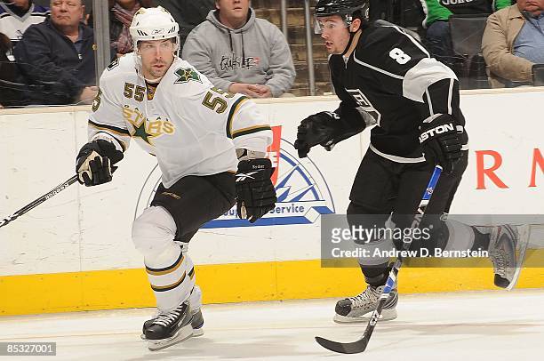 Darryl Sydor of the Dallas Stars skates alongside the boards against Drew Doughty of the Los Angeles Kings during the game on March 5, 2009 at...