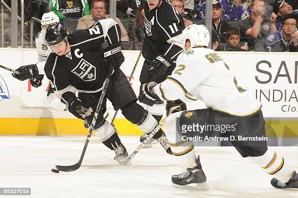 Niklas Grossman of the Dallas Stars reaches for the puck as Dustin Brown of the Los Angeles Kings drives the puck during the game on March 5, 2009 at...