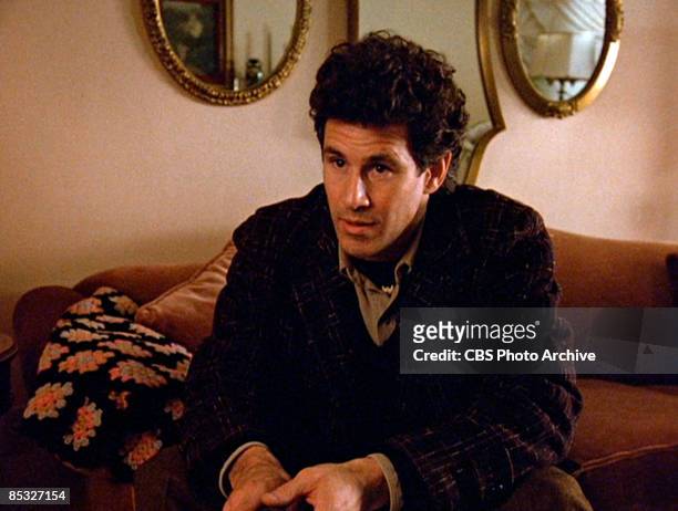 Canadian actor Michael Ontkean sits on a sofa in a scene screen grab from the pilot episode of the television series 'Twin Peaks,' originally...