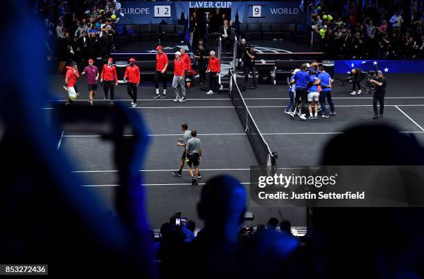 Nick Kyrgios of Team World looks dejected as Team Europe celebrate after Roger Federer of Team Europe wins the Laver Cup on match point during his...