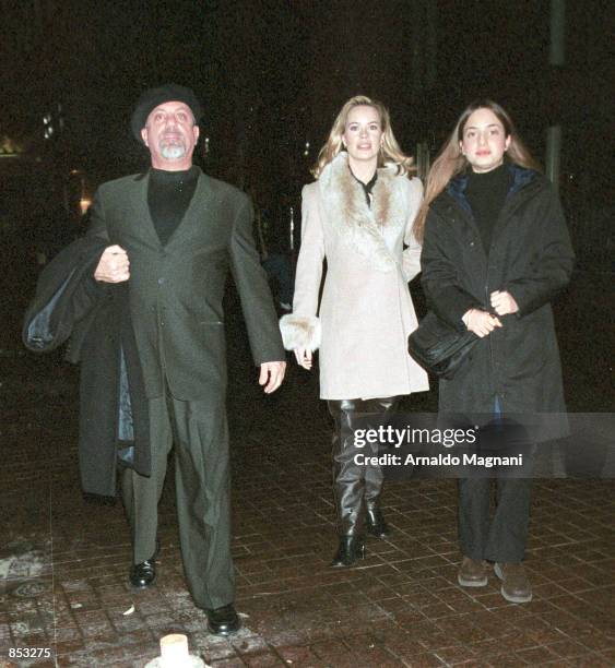 Singer Billy Joel, his new girlfriend, Trish Bergin, and his daughter Alexa leave Vong's Restaurant February 23, 2001 in New York City. Joel and...