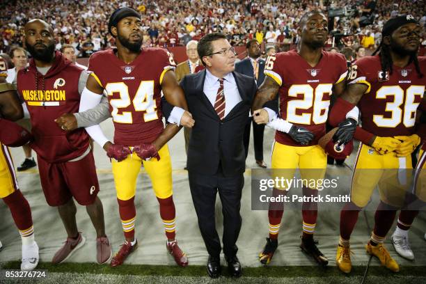 Washington Redskins Owner Daniel Synder stands with cornerback Josh Norman and cornerback Bashaud Breeland during the the national anthem before the...