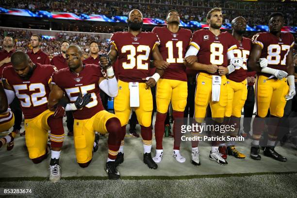 Washington Redskins players during the the national anthem before the game against the Oakland Raiders at FedExField on September 24, 2017 in...
